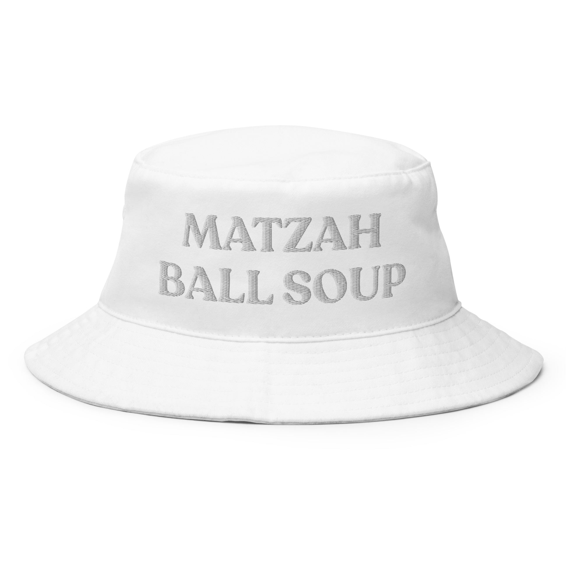 White Matzah Ball Soup Hat - Our Matzah Ball Soup Hat is perfect for everyday streetwear or a funny gift for your favorite yid. It's comfortable, made of 100% cotton and has sewn eyelets for breathability. Eat your fav soup in this funny Jewish bucket hat.