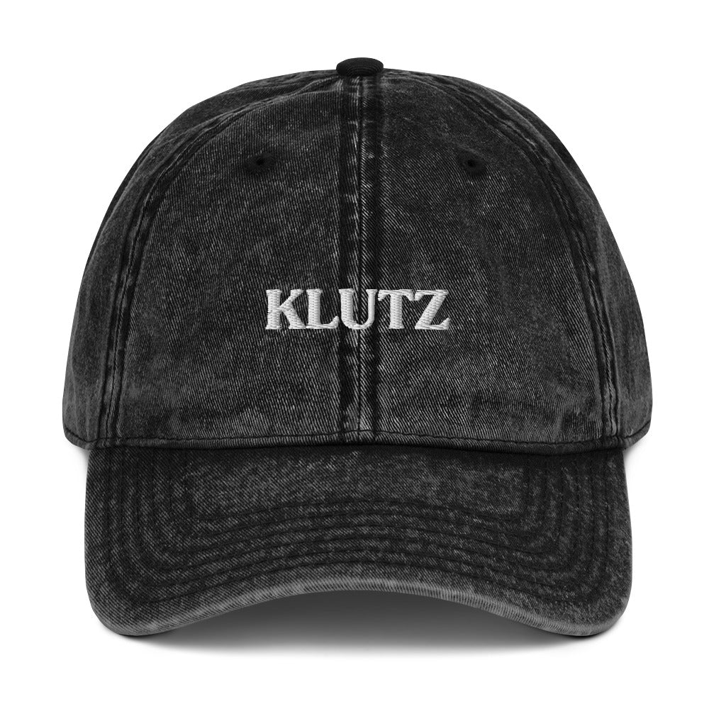 Black Klutz Hat - Are you a klutz? Our klutz hat was made just for you! It's comfortable, adjustable and comes in a variety of colors with a funny design, expertly embroidered on the front. It's the perfect hat for clumsy people or a gift for your klutzy friend.Looking for something personalized? Shoot us a message!