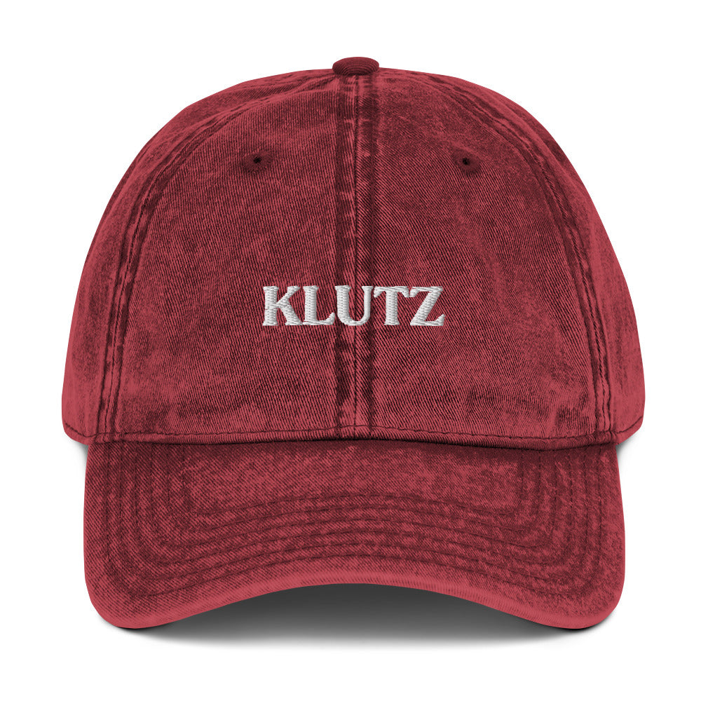 Maroon Klutz Hat - Are you a klutz? Our klutz hat was made just for you! It's comfortable, adjustable and comes in a variety of colors with a funny design, expertly embroidered on the front. It's the perfect hat for clumsy people or a gift for your klutzy friend.Looking for something personalized? Shoot us a message!