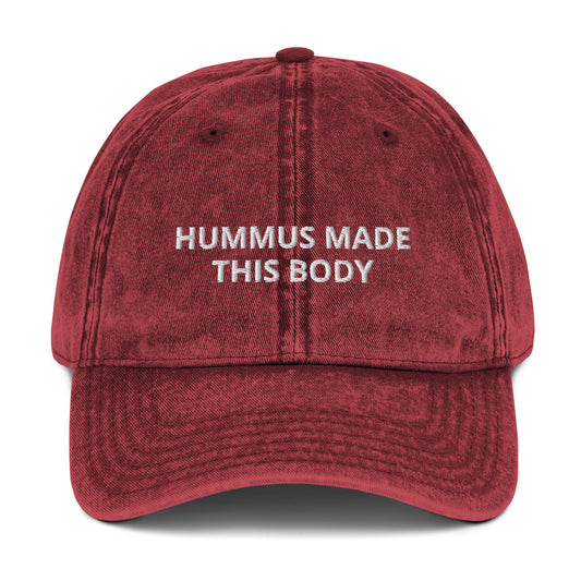 Maroon Hummus Made This Body Hat - Our Hummus Made This Body Hat is comfortable, has an adjustable closure, and is made just for you. It's a classic dad hat with a hummus saying embroidered on the front.