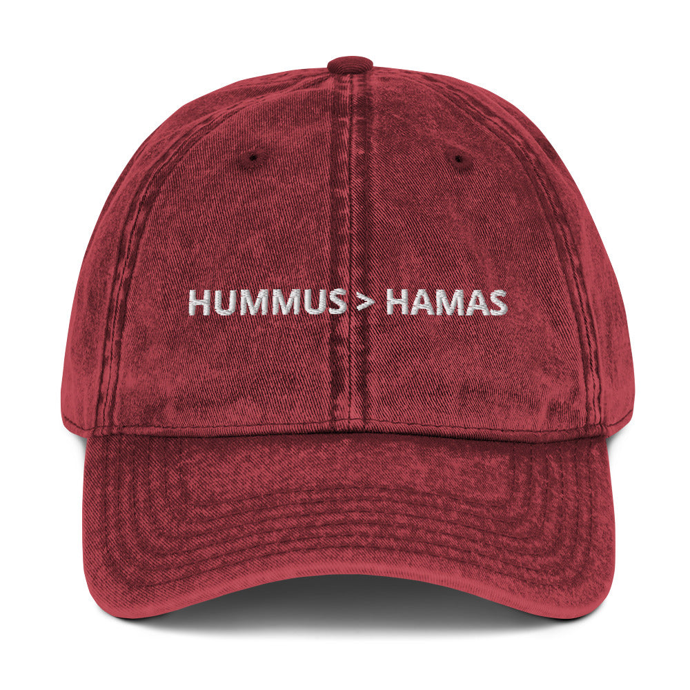 Maroon Hummus is Greater Than Hamas Hat - More Hummus Less Hamas! This dad hat is not just for dads! It's a comfortable cotton hat, expertly embroidered with the anti-terror phrase "HUMMUS > HAMAS". Eat your favorite hummus and let your hat do the talking. This anti-Hamas hat is sure to make a statement. Shop more sarcastic Israel foodie hats at Limonarak!