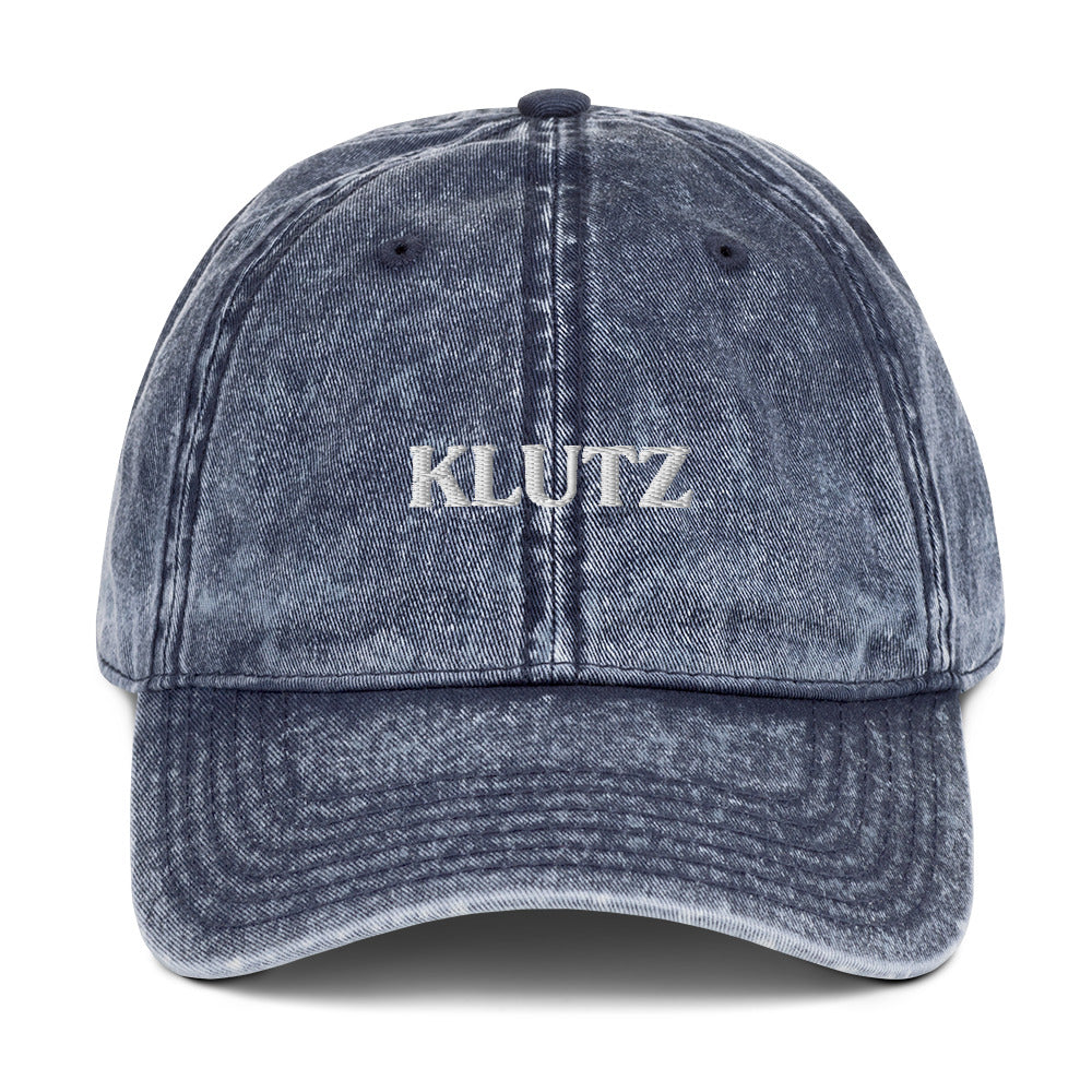 Blue Klutz Hat - Are you a klutz? Our klutz hat was made just for you! It's comfortable, adjustable and comes in a variety of colors with a funny design, expertly embroidered on the front. It's the perfect hat for clumsy people or a gift for your klutzy friend.Looking for something personalized? Shoot us a message!