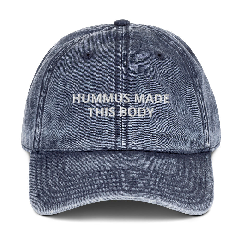 Blue Hummus Made This Body Hat - Our Hummus Made This Body Hat is comfortable, has an adjustable closure, and is made just for you. It's a classic dad hat with a hummus saying embroidered on the front.