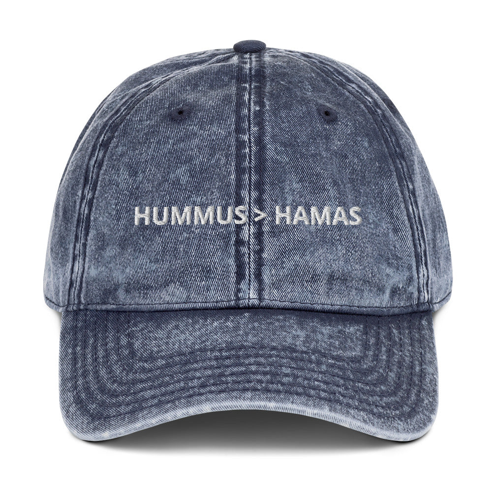 Blue Hummus is Greater Than Hamas Hat - More Hummus Less Hamas! This dad hat is not just for dads! It's a comfortable cotton hat, expertly embroidered with the anti-terror phrase "HUMMUS > HAMAS". Eat your favorite hummus and let your hat do the talking. This anti-Hamas hat is sure to make a statement. Shop more sarcastic Israel foodie hats at Limonarak!