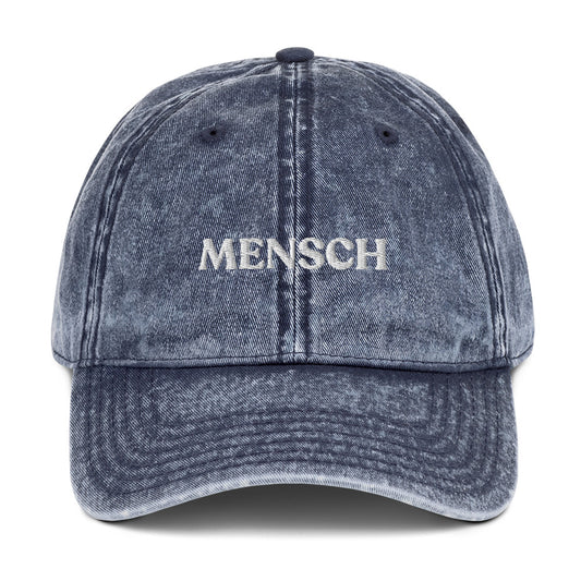 Blue Mensch Hat - Our Mensch hat is adjustable, comfortable and made just for you. It's a classic dad hat with a "Mensch", expertly embroidered on the front. This funny Jewish hat is perfect for everyday streetwear or a gift for your favorite Mensch. 