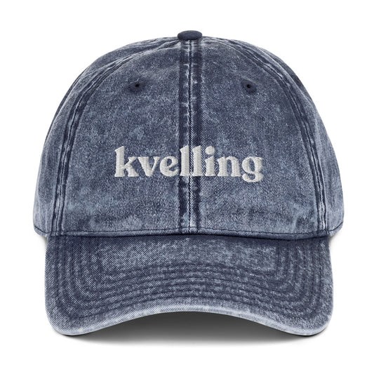 Blue Kvelling Hat - We're kvelling over this yiddish dad hat. It's a classic dad hat with the word "kvellling", expertly embroidered on the front. A funny Jewish hat for everyday streetwear or a gift for your favorite yid. This hat comes in a variety of colors with an adjustable closure and classic dad hat fit. 