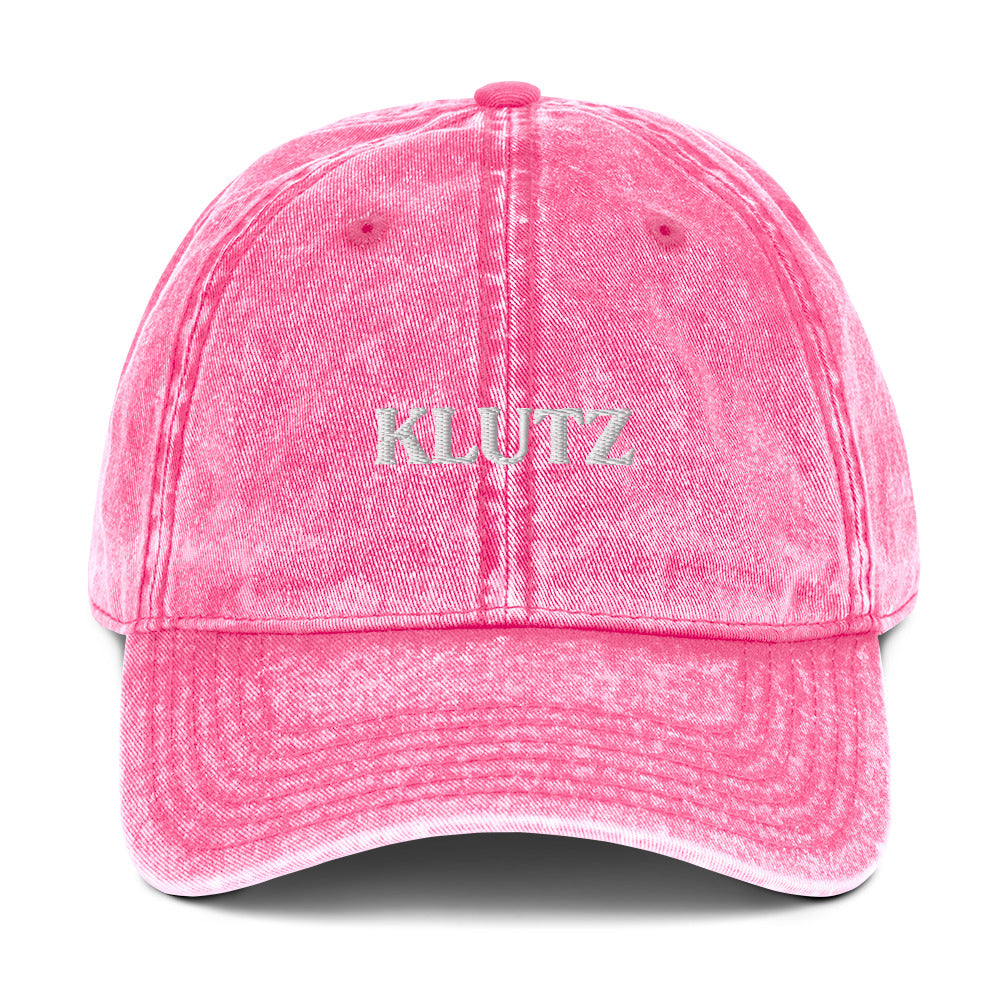 Pink Klutz Hat - Are you a klutz? Our klutz hat was made just for you! It's comfortable, adjustable and comes in a variety of colors with a funny design, expertly embroidered on the front. It's the perfect hat for clumsy people or a gift for your klutzy friend.Looking for something personalized? Shoot us a message!